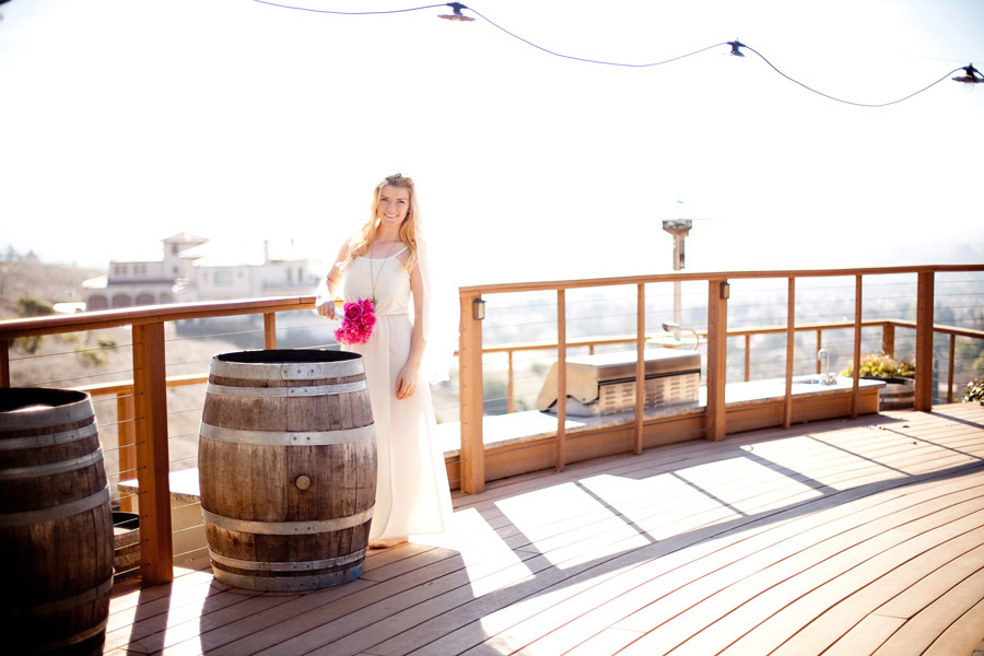 Bride standing on deck overlooking the city of San Jose.