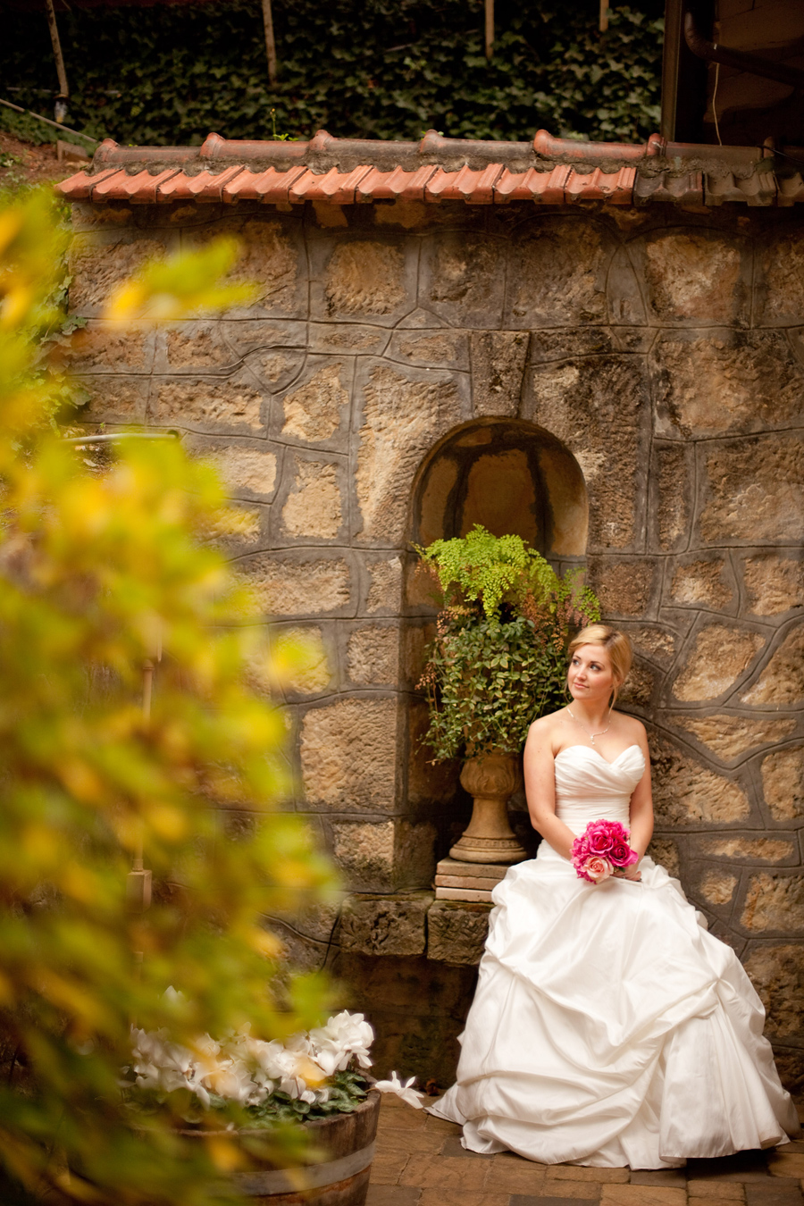 Bride sits outside the wedding venue.