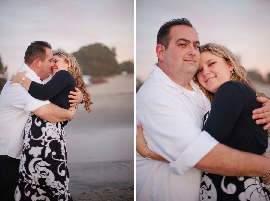 The couple embrace on the Santa Cruz beach as the sunsets.