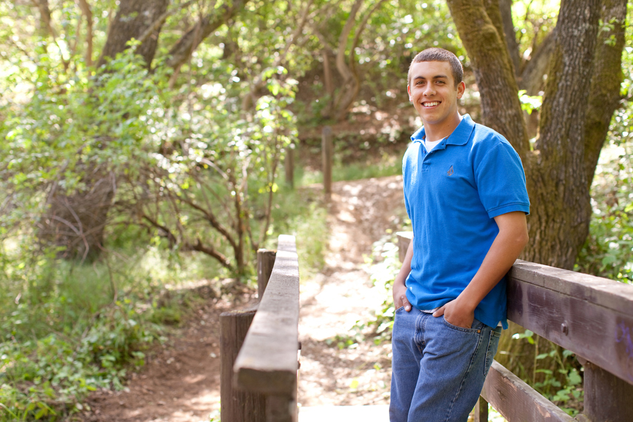 In the shade at Gilroy's park, Tyler smiles for his senior portraits.