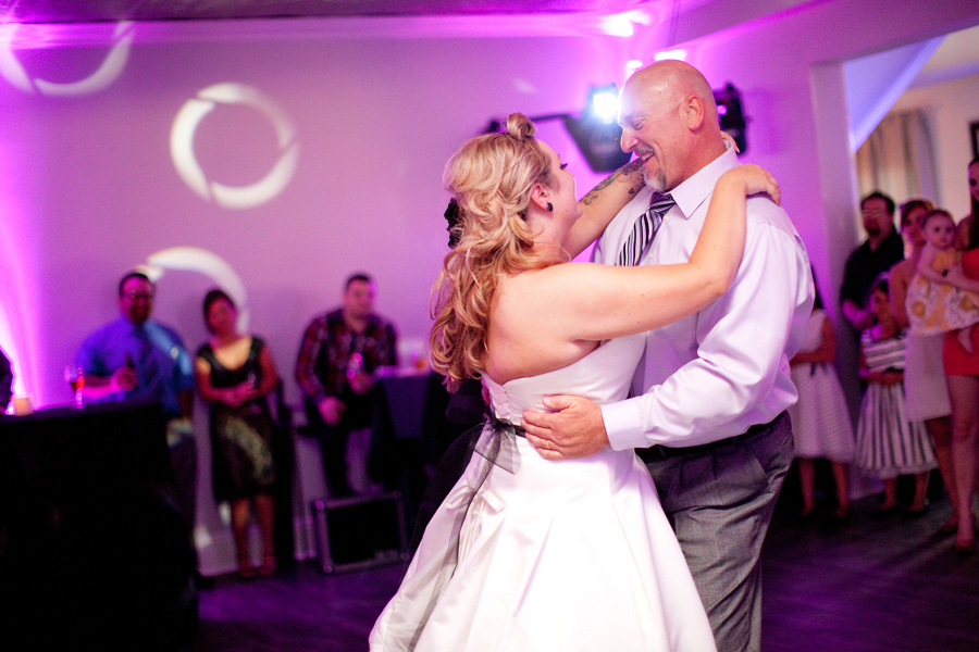 The bride dances with her dad during the wedding reception.