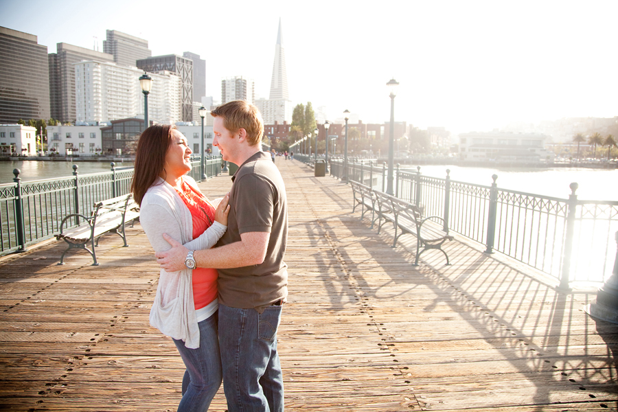 The couple stands on the pier in San Francisco.