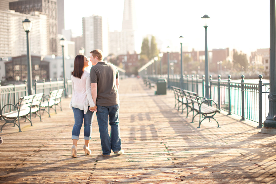 Sarah and Kyle walk down the pier to the city of San Francisco.