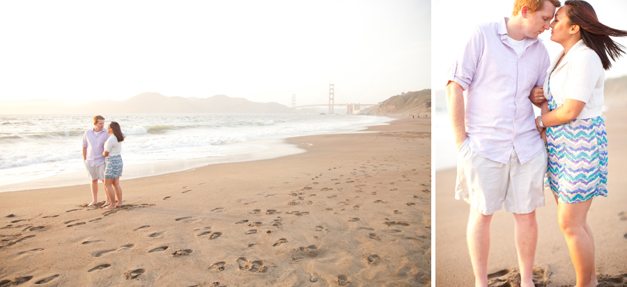 The couple stands on Baker Beach in front of the Golden Gate Bridge.