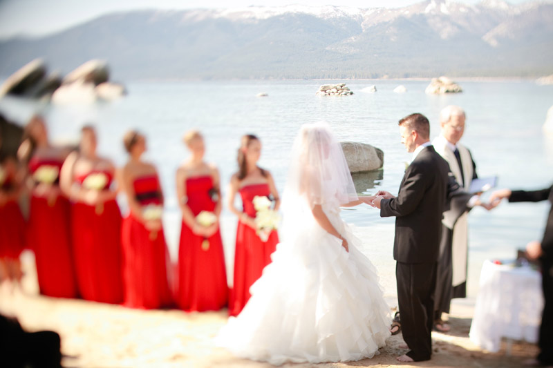 The groom says his vows and exchanges the rings in front of Lake Tahoe.