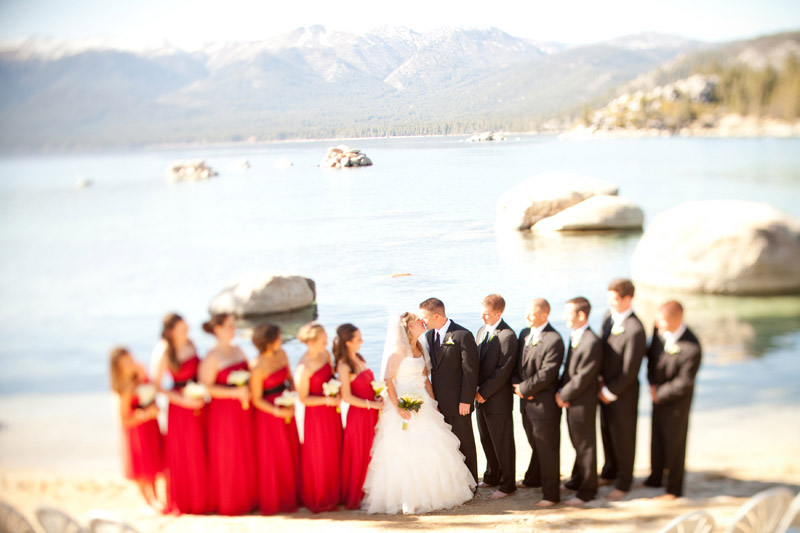 The bride and groom kiss in front of the wedding party at Sand Harbor State Park in Lake Tahoe.