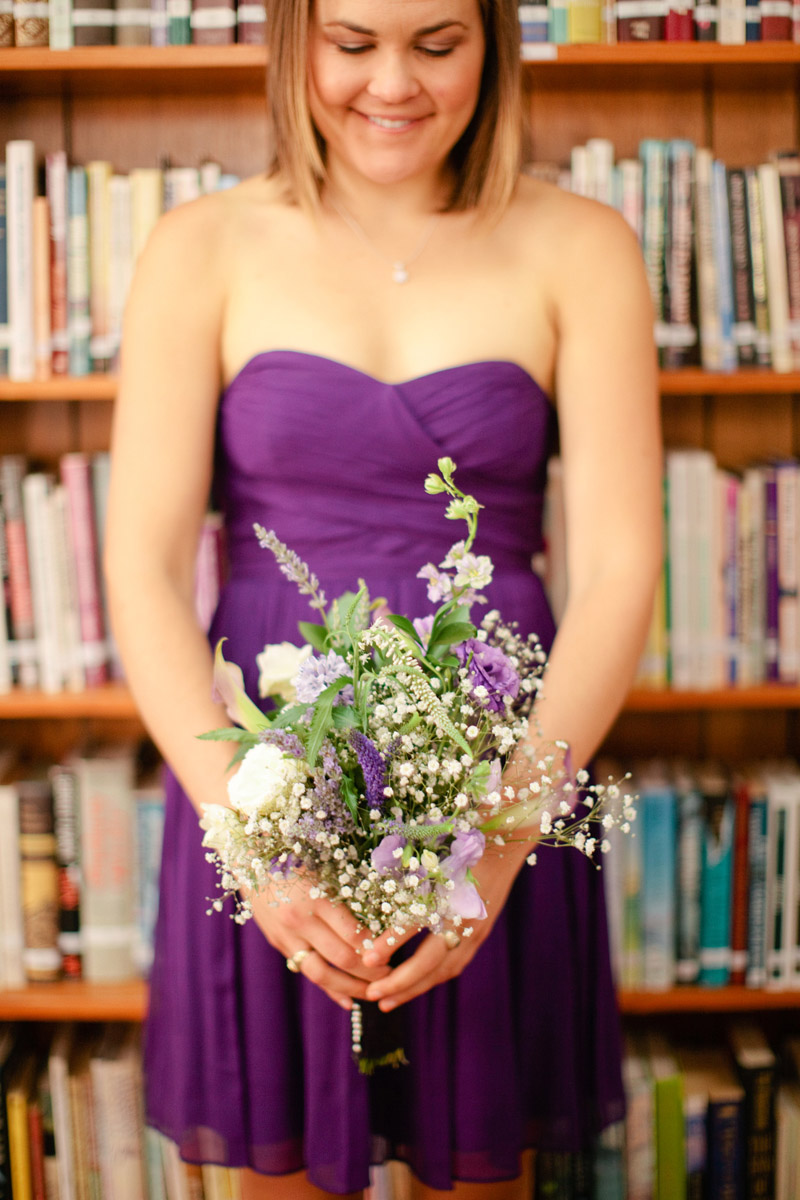 Bridesmaid holding a bouquet before the wedding ceremony in Monterey.