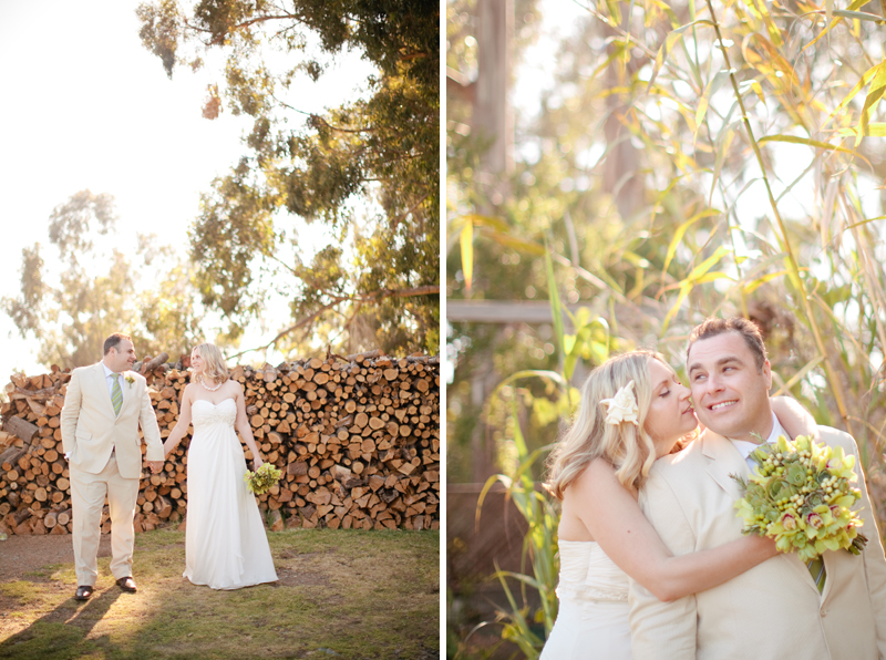 The bride and groom smile at each other in front of the log pile at Point 16.