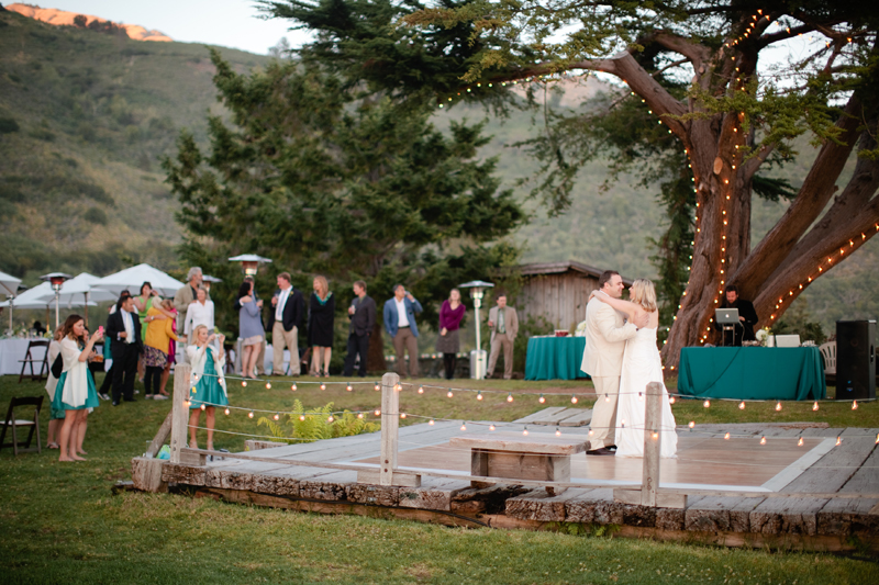 Wedding guests look on as the two share their first dance at their Big Sur wedding.