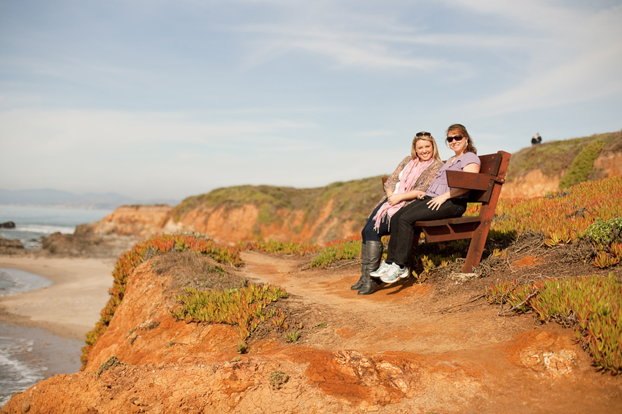 My mom and I sitting on a bench overlooking Pescadero State Beach.