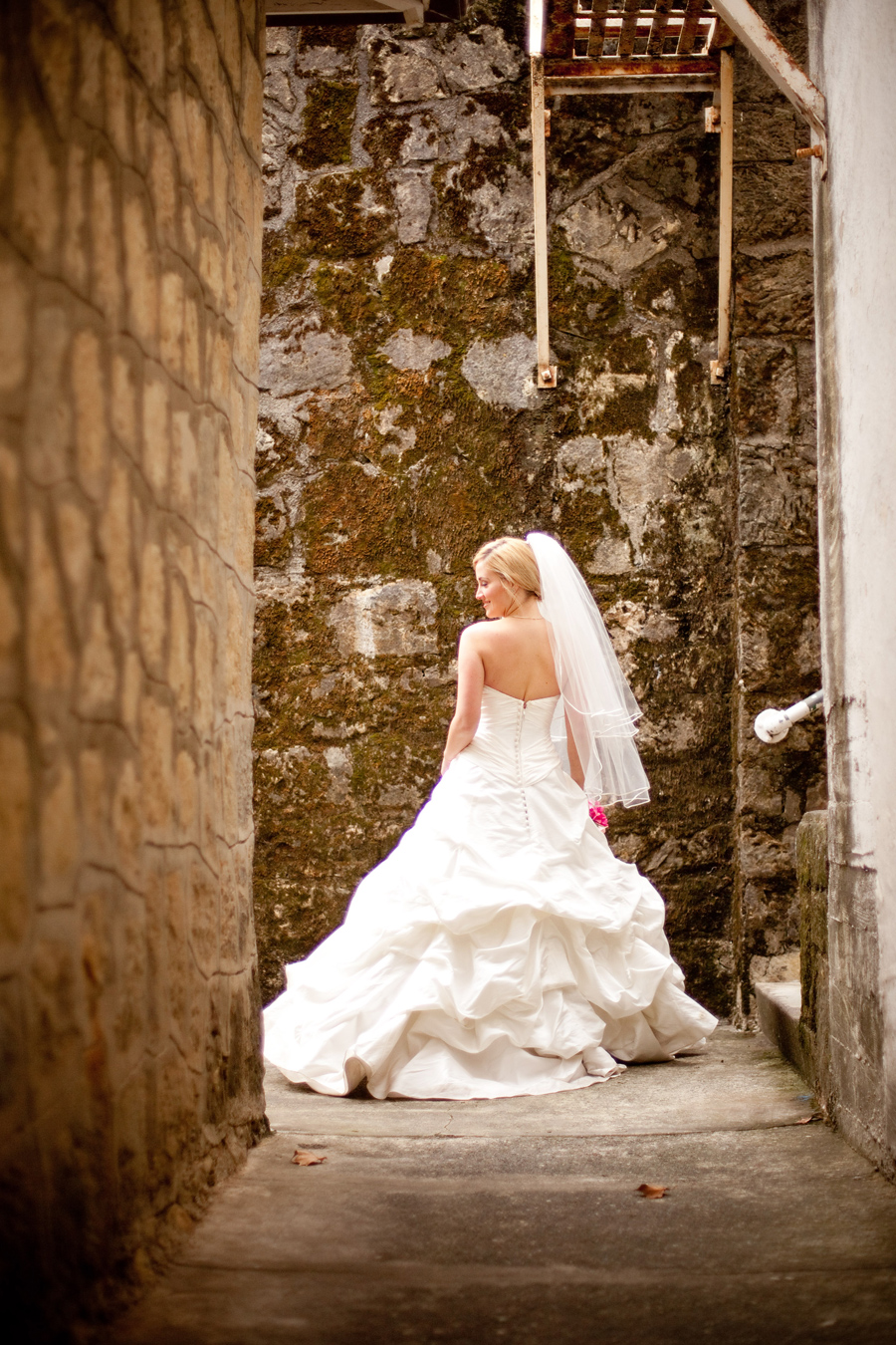 Bride dances in walkway at Los Gatos wedding venue.