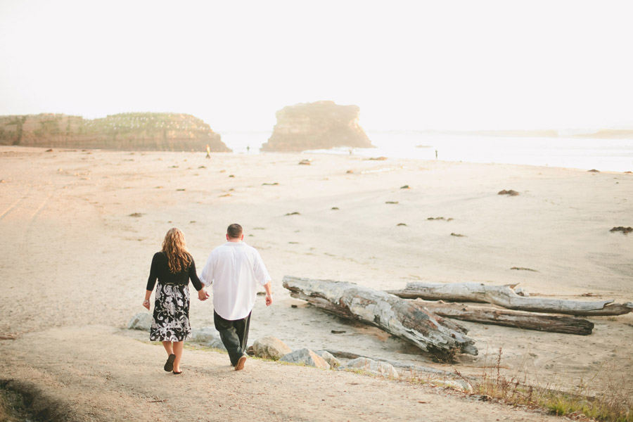The couple walks down to the Santa Cruz shoreline at Natural Bridges State park.